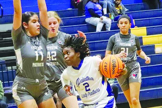 Palatka’s Zy’ria Jones tries to dribble around Orlando Freedom’s Mona El Dali (11) and Rachel Daily during Wednesday’s opening-round match won by Palatka, 44-34. (RITA FULLERTON / Special to the Daily News)