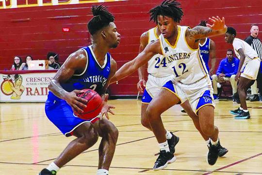 Palatka’s Jamarrie McKinnon (12) races out to defend Interlachen’s Der’Tavious Mack during Thursday’s game in the Pooh Bear Williams Classic at Crescent City Junior-Senior High School. (RITA FULLERTON / Special to the Daily News)
