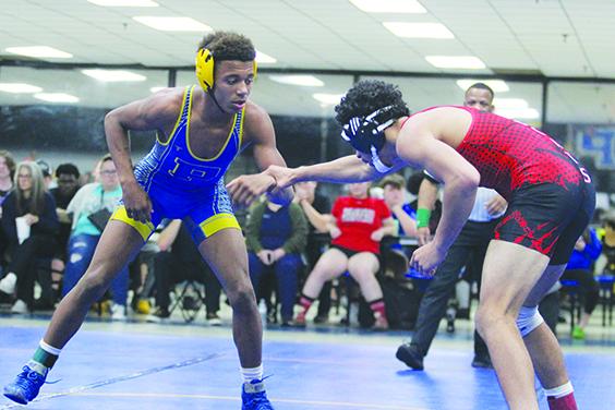 Palatka’s Mikade Harvey measures out Baker County’s Keith Ratliff in the 152-pound match Tuesday night. Harvey won by technical fall. (MARK BLUMENTHAL / Palatka Daily News)