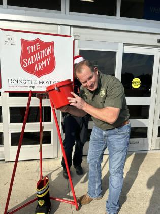 Putnam County Sheriff Gator DeLoach shakes a donation bucket during a fundraising competition between the sheriff's office and Putnam County Fire Rescue. Photo courtesy of Putnam County Fire Rescue.