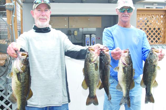 Frank Streeter and Robin Hodges hold up their winning fish recently. (GREG WALKER / Daily News correspondent)