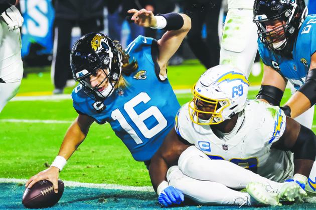 Jaguars quarterback Trevor Lawrence scores on the 2-point conversion in the fourth quarter. (JOHN STUDWELL / Special to the Daily News)
