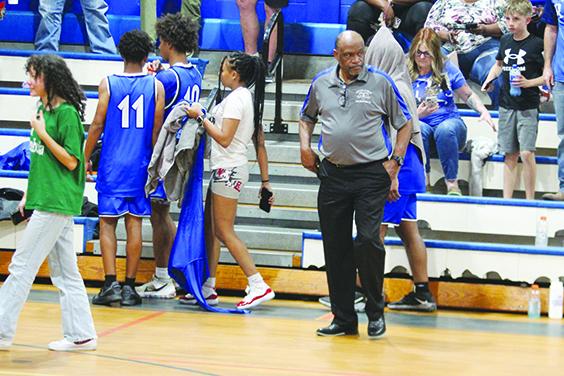 Interlachen coach C.S. Belton watches Gainesville P.K. Yonge players celebrate their 54-41 championship victory over his Rams. (MARK BLUMENTHAL / Palatka Daily News)