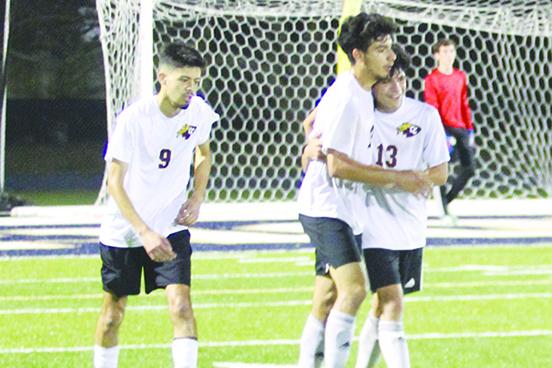 Jesus Cruz (middle) gets hugged by Crescent City teammate Angel Consuelos after scoring his second goal of the game. Jeremiah Carbajal looks on. (MARK BLUMENTHAL / Palatka Daily News)