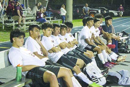 Crescent City Junior-Senior High School substitute players watch from the bench in the final minutes of the Raiders’ 5-2 Region 3-3A semifinal round loss against host Melbourne Holy Trinity Episcopal Saturday night. (MARK BLUMENTHAL / Palatka Daily News)