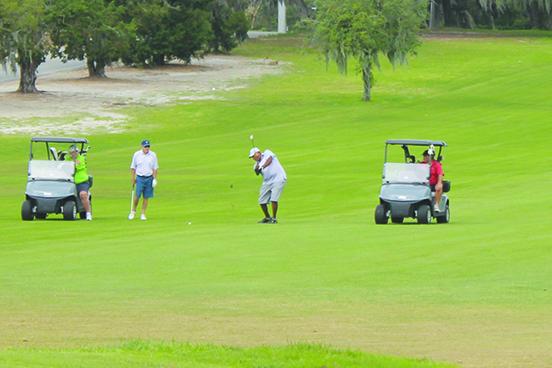 Ed Pierce, sending a shot to the ninth green in Friday’s first round, was tops among local competitors at the Senior Azalea Amateur. (MARK BLUMENTHAL / Palatka Daily News)