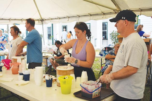BRANDON D. OLIVER/Palatka Daily News A volunteer prepares an ice cream cone to serve to an attendee of the Bostwick Blueberry Festival on Saturday.