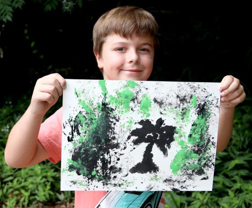 Joel Thomas, 8, of Palatka shows his completed Street Art project he made during the Palatka Art League Kids Summer Art Program camp on Wednesday.