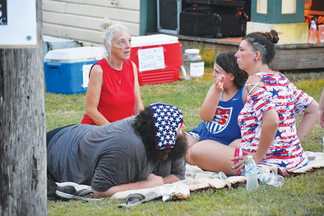 A family picks their spot in downtown Interlachen to watch the fireworks show that will occur in the town.