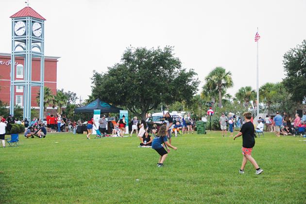 Children at the Palatka riverfront play a game involving a volleyball Tuesday evening before the city’s fireworks show begins.