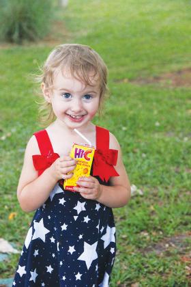 Serenity Wilkins, 2, enjoys some juice at the Palatka riverfront on the Fourth of July.