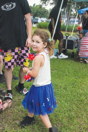 Ariella Gross, 4, of Palatka shows off her red, white and blue outfit while waiting for fireworks at the Palatka riverfront.