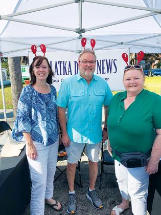 File photo -- Joyce Guthrie, right, stands underneath the Palatka Daily News’ tent at the 2022 Blue Crab Festival.