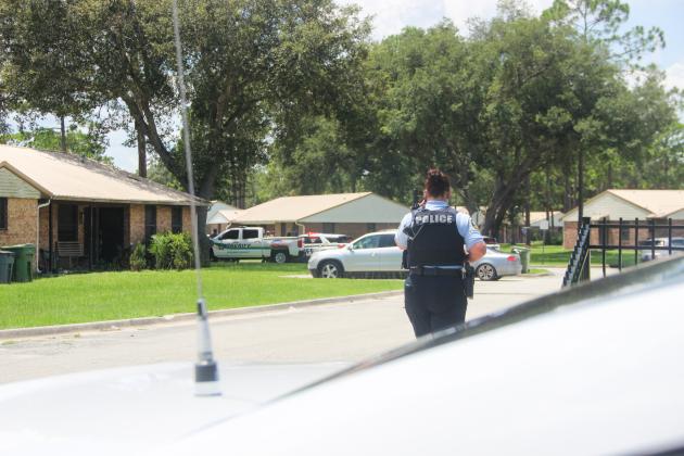 SARAH CAVACINI/Palatka Daily News. A Palatka Police Department officer walks in the front of the Rosa K. Ragsdale Community on Tuesday.