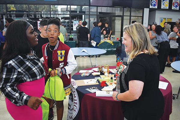 BRANDON D. OLIVER/Palatka Daily News – Christina McNiel, right, the director of admissions and student services for Dragon Rises College of Oriental Medicine, talks to local students about what the school offers during the Putnam County College & Career Fair on Tuesday.