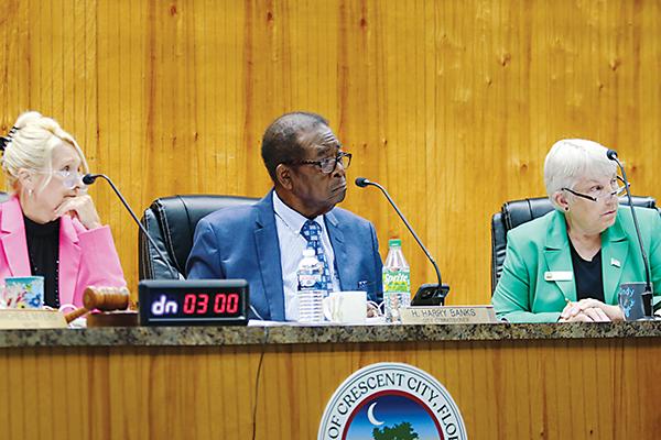 SARAH CAVACINI/Palatka Daily News – From left, Crescent City Mayor Michele Myers and Commissioners Harry Banks and Cynthia Burton listen to opinions about reimbursing Myers and Burton for their legal fees.