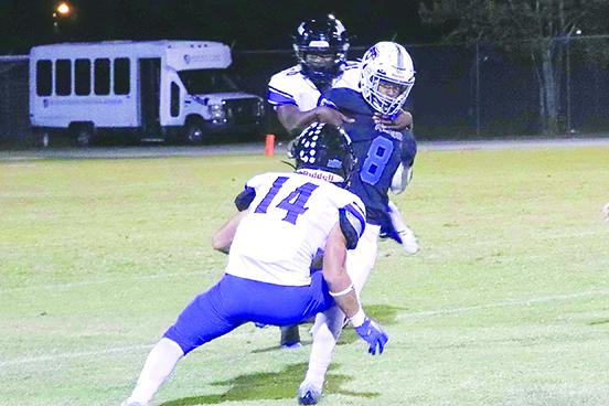 Interlachen’s Dante Astin (8) is corraled down by Mount Dora Christian’s Xavier Dalton (behind) and Jourdan Betances during last Friday night’s game. (RITA FULLERTON / Special to the Daily News)