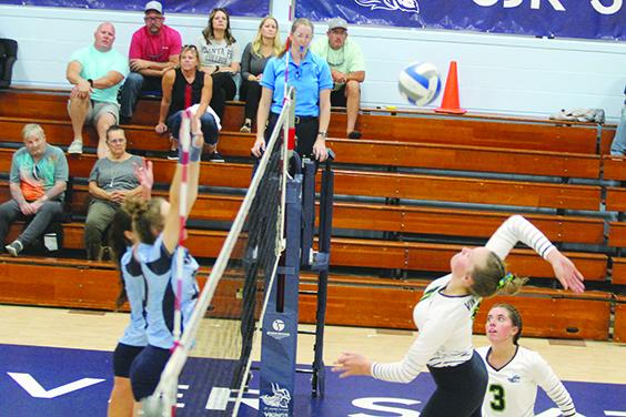 St. Johns River State College’s Brittany Cowart goes high for a kill attempt against two Santa Fe defenders during Tuesday’s match at Tuten Gymnasium. (MARK BLUMENTHAL / Palatka Daily News)