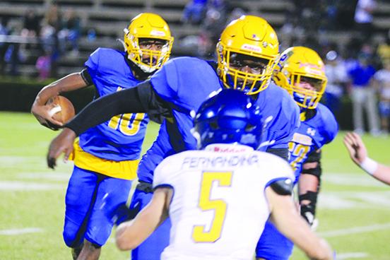 With lineman Jaquez Poole pulling out in front of Fernandina Beach’s Camden Boyd, Palatka quarterback Tommy Offord looks for running room during the Panthers’ 29-16 win over the Pirates Friday. (MARK BLUMENTHAL / Palatka Daily News)
