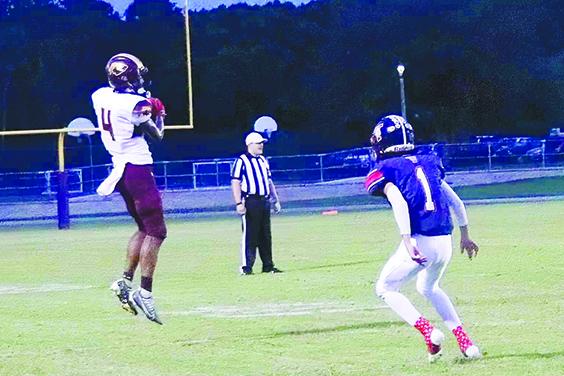 Crescent City’s Lentavious Keenon (4) catches a pass last Friday night in front of Pierson Taylor’s Alex Gomez. (RITA FULLERTON / Special to the Daily News)