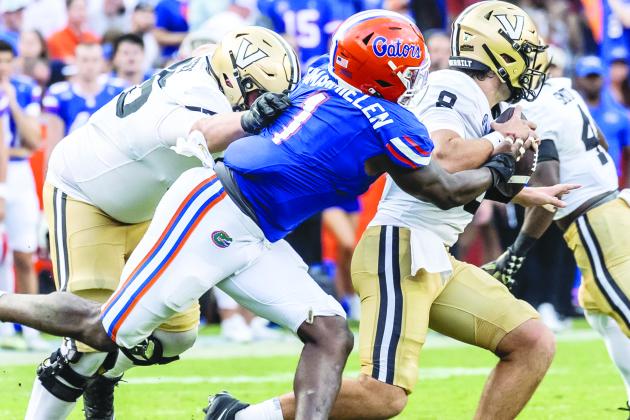 Florida’s Princely Umanmielin is able to get to Vanderbilt quarterback Ken Seals for a sack during Saturday’s Gators 38-14 victory. (JOHN STUDWELL / Special to the Daily News)