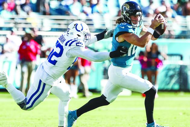  Jacksonville Jaguars quarterback Trevor Lawrence escapes the tackle attempt of the Indianapolis Colts’ Samson Ebukam during the Jaguars’ 37-20 victory on Sunday at EverBank Field. (JOHN STUDWELL / Special to the Daily News)