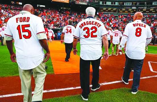 Bill Swaggerty (center) walks out to the field at Oriole Park at Camden Yards with former teammates Danny Ford (15) and Cal Ripken Jr. in August as the 40th anniversary of the 1983 World Series champion Baltimore Orioles are honored. (Photo by Baltimore Orioles)