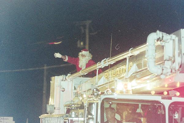 File photo – Santa Claus waves to the crowd at a Palatka Christmas Parade decades ago.