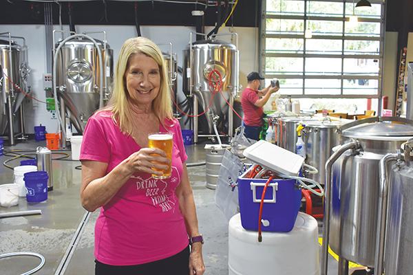 BRANDON D. OLIVER/Palatka Daily News – Azalea City Brewing Co. owner Andrea Conover holds a beer in her taproom during the business' third-anniversary celebration.