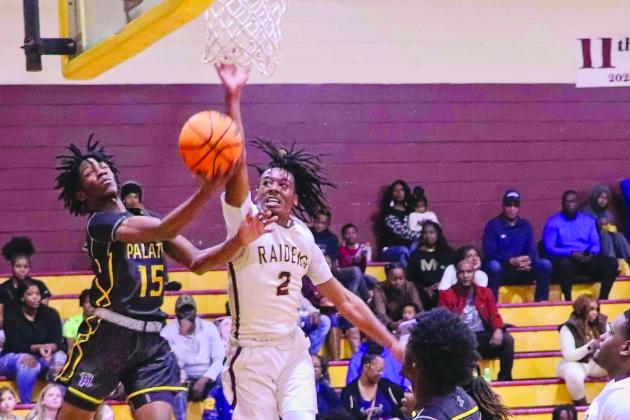 Palatka’s Dequan Jackson (15) puts a shot up against Crescent City’s Eric Jenkins Jr. during last week’s game in the Pooh Bear Williams Classic at Crescent City Junior-Senior High School. (RITA FULLERTON / Special to the Daily News)