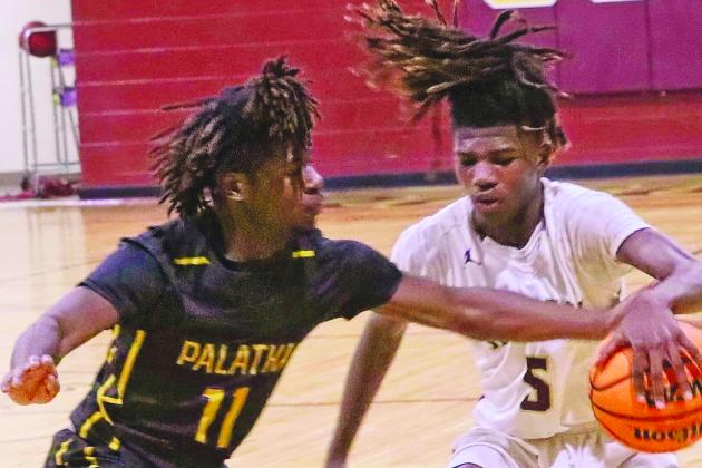 Palatka’s Tarik Castor (11) guards Crescent City’s Tyrone Jenkins carefully during the first half of Friday night’s game. (RITA FULLERTON / Special to the Daily News)