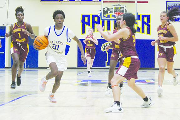Palatka’s Deandra Fields (21) pushes the ball up the court against Crescent City’s Kirabella Williams during Wednesday night’s game. (MARK BLUMENTHAL / Palatka Daily News)