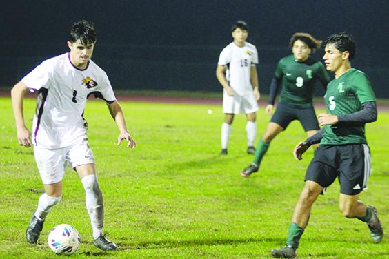 Crescent City's David Newbold (left) looks to control the ball against Daytona Beach Father Lopez defender Gabe Jimenez during Thursday night's Raider 2-0 win over the Green Wave. (MARK BLUMENTHAL / Palatka Daily News)