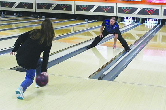 Palatka Junior-Senior High School bowling coach Kelly Lake (right) goes through a drill with junior Ashley Griffis during a practice in late October at Putnam Lanes. (MARK BLUMENTHAL / Palatka Daily News)