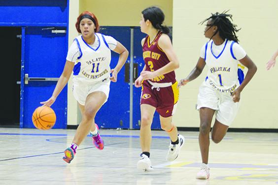 Palatka’s Charnelle Cue brings the ball up the floor next to Crescent City’s Kirabella Williams as Panthers teammate J’hane Fountain runs with her. (MARK BLUMENTHAL / Palatka Daily News)