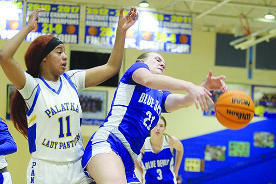 Clay High School’s Julia Weaver (21) battles for a rebound with Palatka’s Charnelle Cue during Wednesday night’s girls basketball game. (MARK BLUMENTHAL / Palatka Daily News)