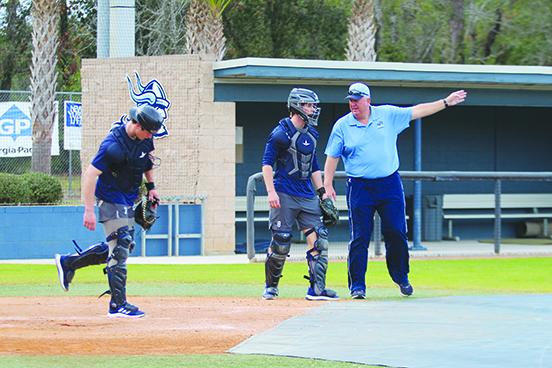 St. Johns River State College baseball coach Ross Jones (right) makes a point to catcher Ben Barrow (center) while Tripp Davis listens in during Tuesday’s practice. (MARK BLUMENTHAL / Palatka Daily News)