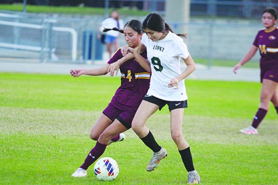 Crescent City’s Abigail Medina (left) and Daytona Beach Father Lopez’s Barbara Arreola go after a loose ball Friday night in the District 9-3A girls soccer semifinals. (MARK BLUMENTHAL / Palatka Daily News)