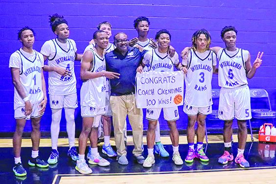  Interlachen Junior-Senior High School boys basketball coach Bryant Oxendine (cener) poses with his Rams after defeating St. Augustine Florida Deaf & Blind, 61-10, for his 100th career victory Thursday night at the C.S. Belton III Fieldhouse. (RITA FULLERTON / Special to the Daily News)