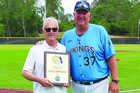 St. Johns River State College President Joe Pickens and baseball coach and athletic director Ross Jones pose with the Region 8 championship the Vikings won last May. (Submitted / St. Johns River State College)