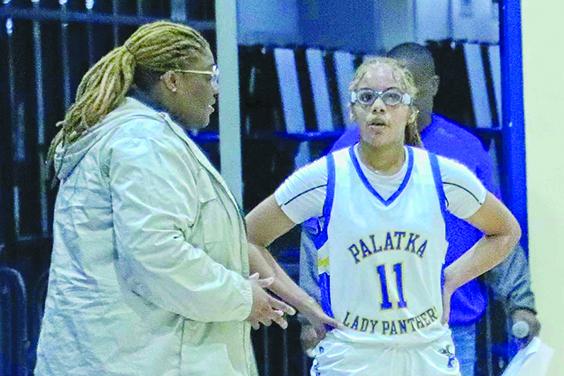 Palatka co-girls basketball coach Jonell Williams talks to Charnelle Cue during a break. (RITA FULLERTON / Special to the Daily News)