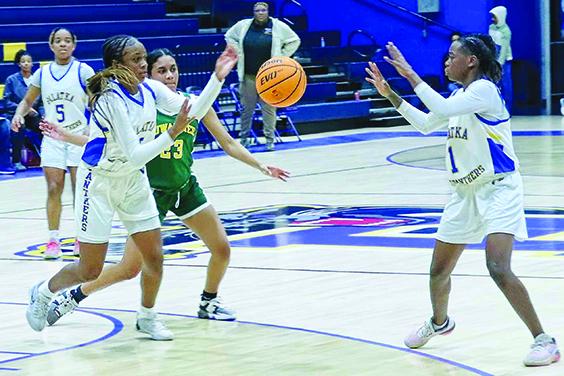 Palatka’s Destiny Williams (left) gets her pass off to teammate J’hane Fountain during Wednesday night’s game. (RITA FULLERTON / Special to the Daily News)