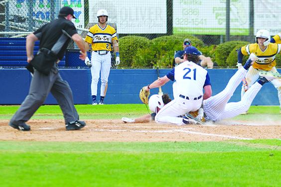 Florence-Darlington’s Devin Mitchell slides safely into home plate ahead of the tag attempt of St. Johns River State College pitcher Caden Kok (21) to give his team a 5-4 lead in the sixth inning on Friday in the John Tindall Classic at Tindall Field. (MARK BLUMENTHAL / Palatka Daily News)