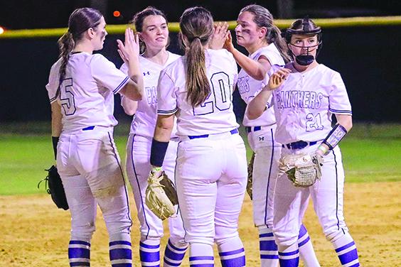 Palatka Junior-Senior High School softball players huddle up after calling a timeout to talk to one another during Friday night’s game at home against Baldwin. (RITA FULLERTON / Special to the Daily News)