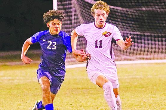 Crescent City’s Levi Keefauver (11) brings the ball up against Pierson Taylor’s Danny Carballo Wednesday night. (RITA FULLERTON / Special to the Daily News)