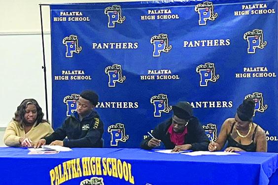 Palatka’s Ar’Terrian Godfrey (second, left) and Cartaveon Valentine (second, right) sign letters of intent to continue playing football and studying at Concord University in West Virginia. Alongside Godfrey is his mom, Tanisha Young, and next to Valentine is his mother, Anariahh Valentine. (Submitted / Facebook)
