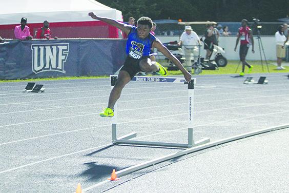 Palatka’s Derick Holland leaps over a hurdle in last year’s 400-meter individual hurdles at the FHSAA 2A championship meet at the University of North Florida. (MARK BLUMENTHAL / Palatka Daily News)