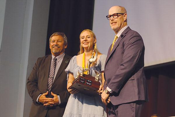 SARAH CAVACINI/Palatka Daily News – Crescent City Junior-Senior High School student Emme Delaney, center, stands with Superintendent Rick Surrency, left, and presenter Douglas Webb after receiving the Robert W. Webb Award of Excellence during Tuesday’s Top Scholar Awards Ceremony.