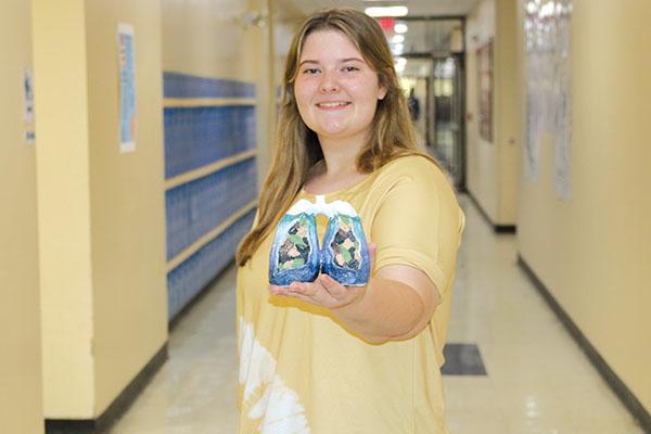 TRISHA MURPHY/Palatka Daily News  Palatka Junior-Senior High School 11th grade student Bella Thomas, 17, shows the “Lungs of the Ocean” sculpture she created that was one of 150 artworks nationwide selected to be exhibited last month in Virginia.