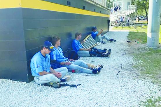 St. Johns River State College baseball players sit dejectedly behind their dugout after losing the opening game of a doubleheader Friday, giving Pasco-Hernando the Sun-Lakes Conference title. (COREY DAVIS / Palatka Daily News)